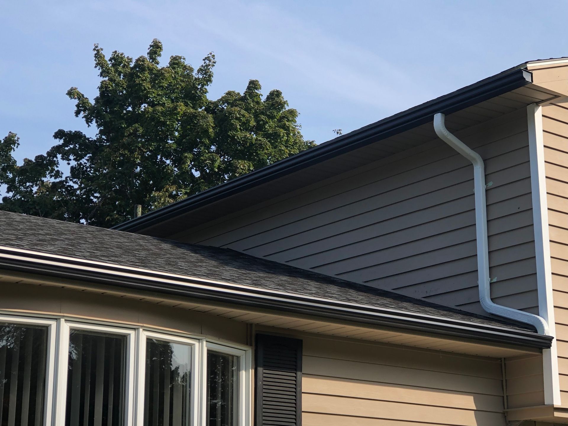 New New downspout installed on a two story house