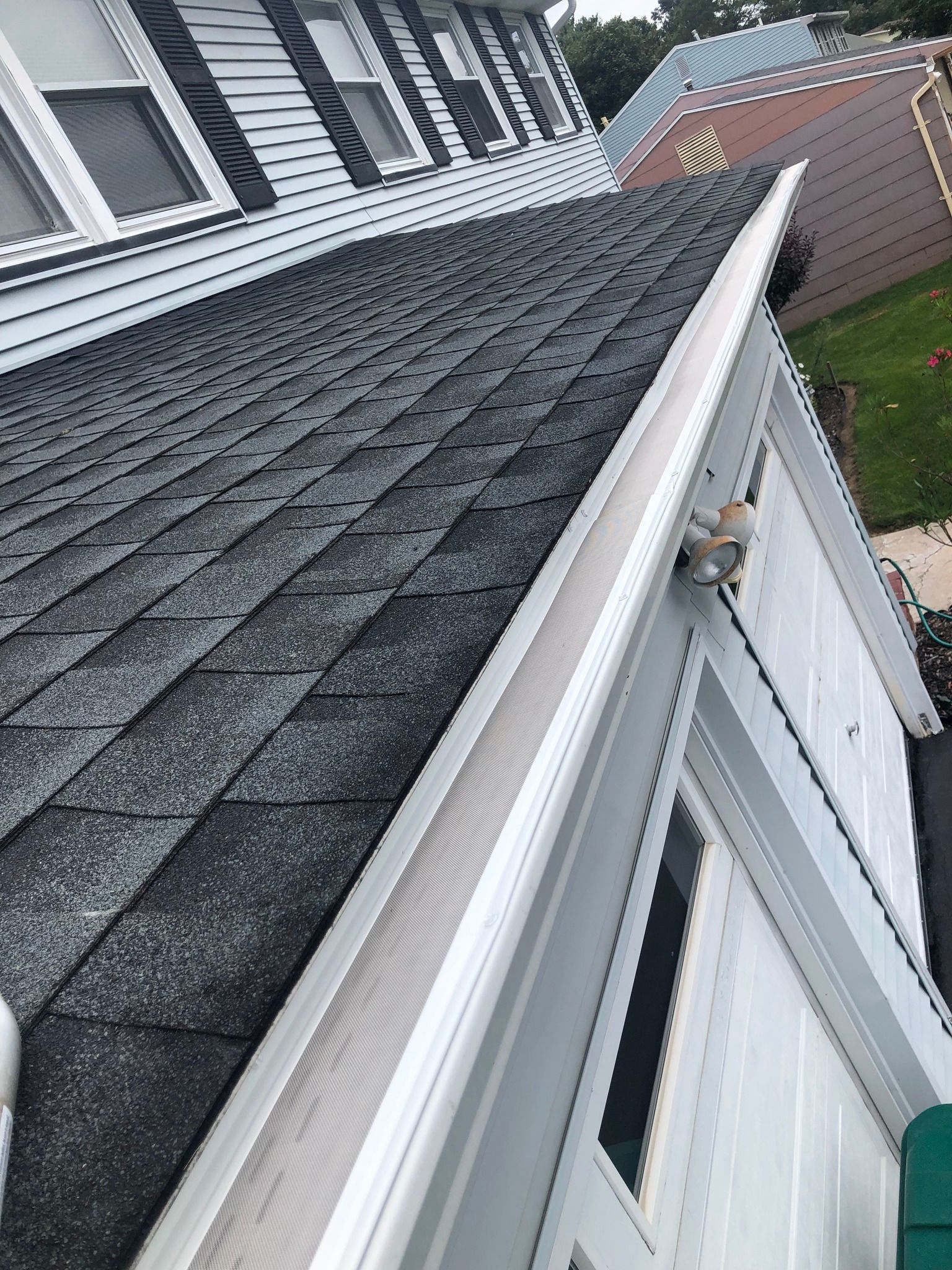 New gutter guards installed on a gutter system, seen from above