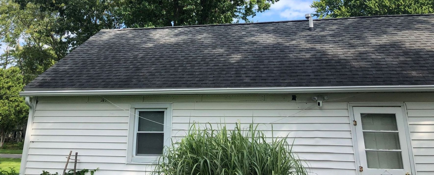 Newly installed gutters on a white home