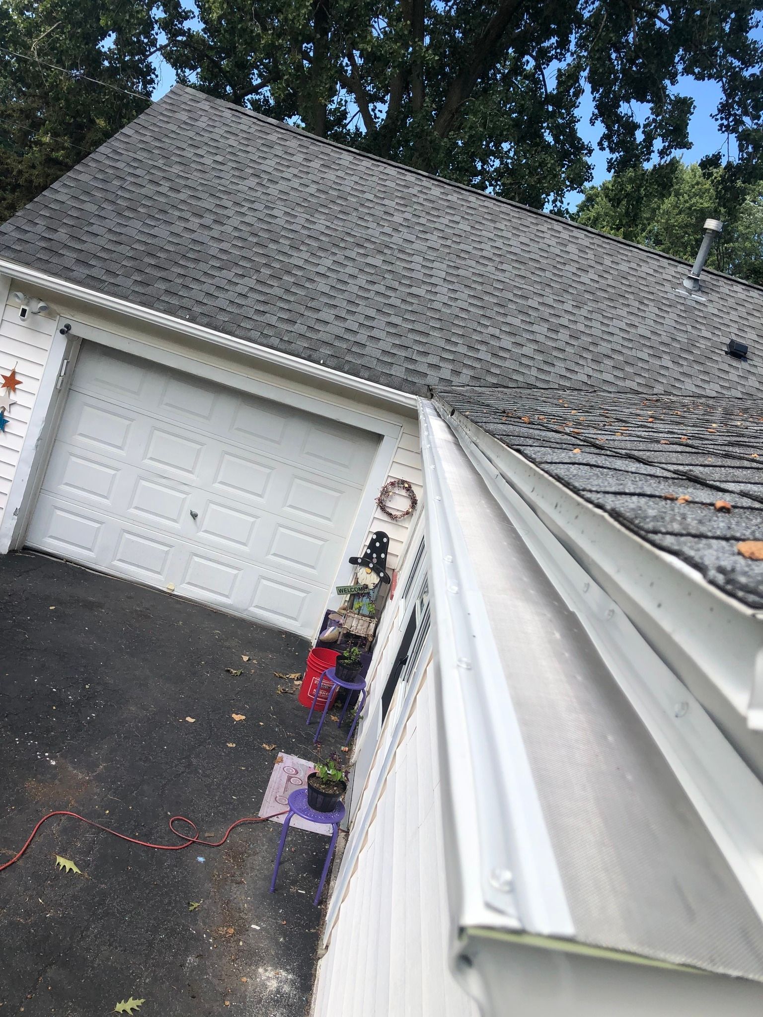 The side of a white house before a new gutter system is put in place