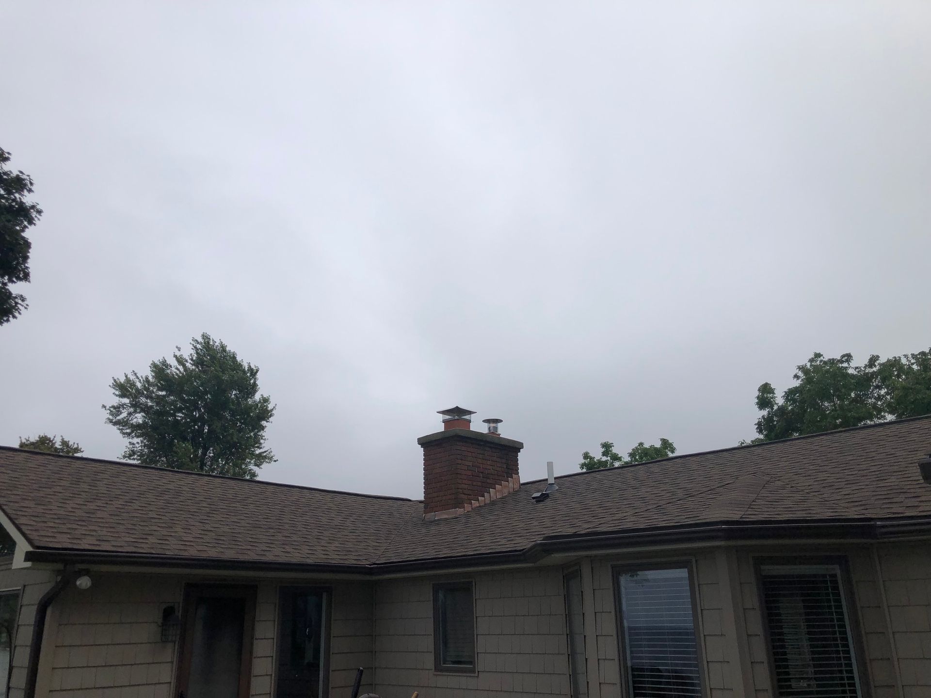 A wide shot of newly installed black gutters from a distance