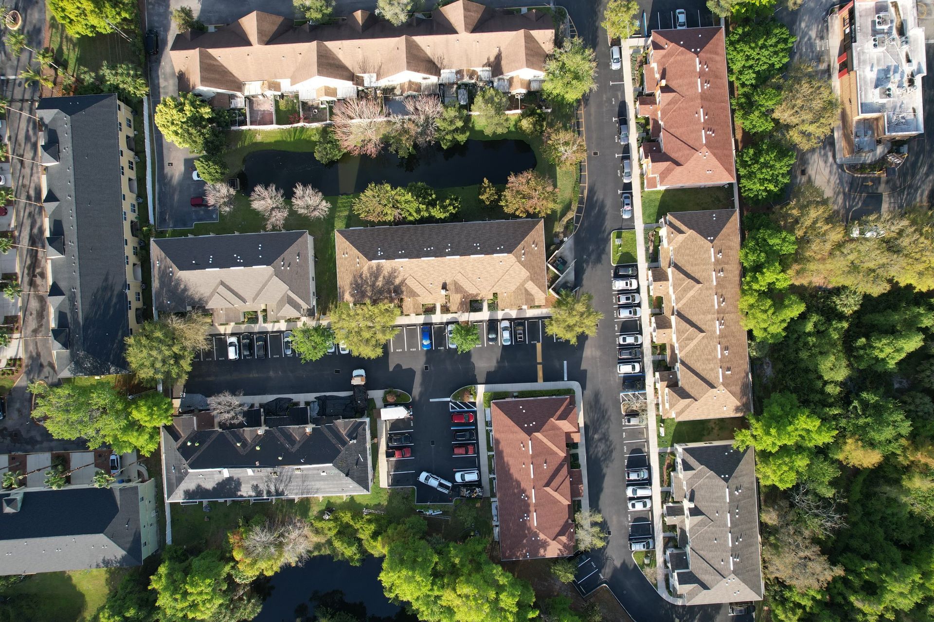Aerial view of a coastal city with a body of water, road, and buildings under a blue sky. Aerial view of a coastal city with a body of water, road, and buildings under a blue sky.