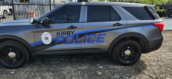 Kirby Police SUV parked on gravel, black and gray with blue lettering