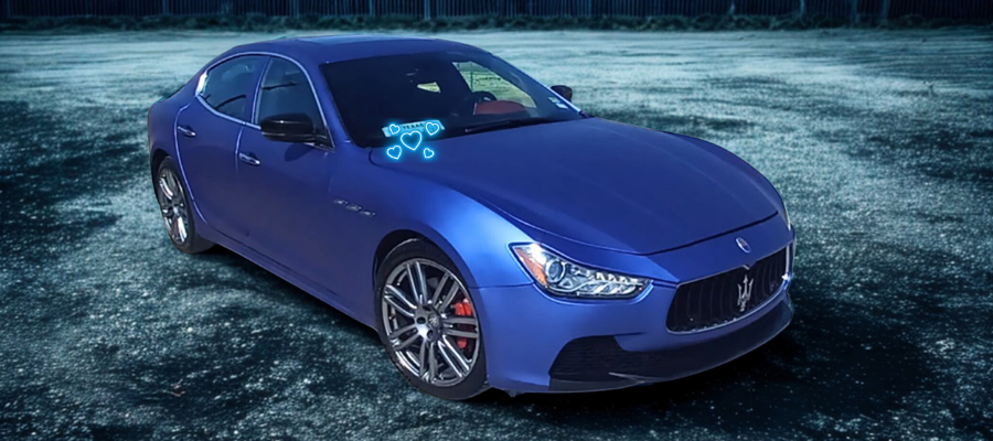 Blue sports sedan parked on a dark road, front-left view, with headlights off and tinted windows.