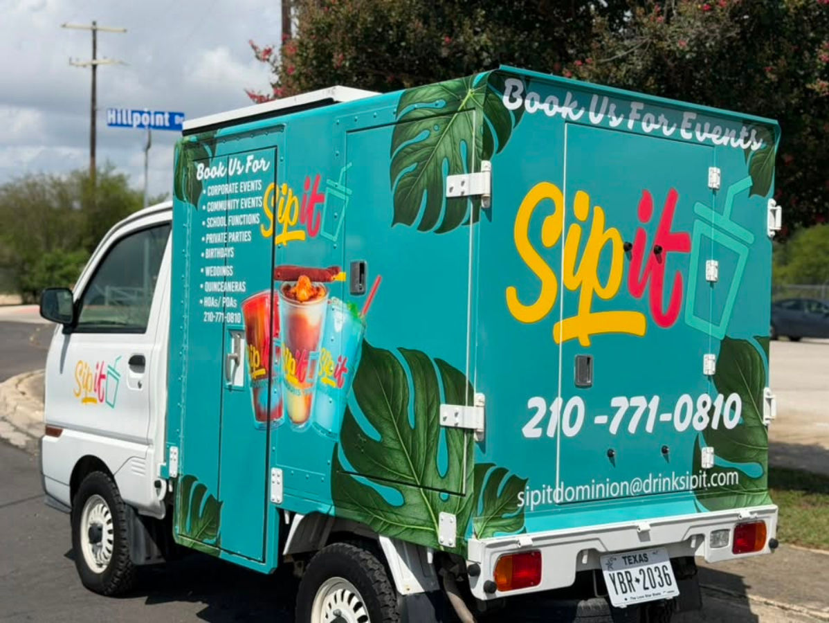 Turquoise Sipi delivery truck with palm leaf graphics parked on a street