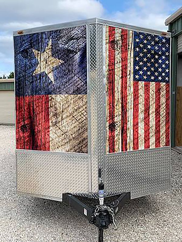 Trailer wrapped in Texas and U.S. flag designs with a hitch in front