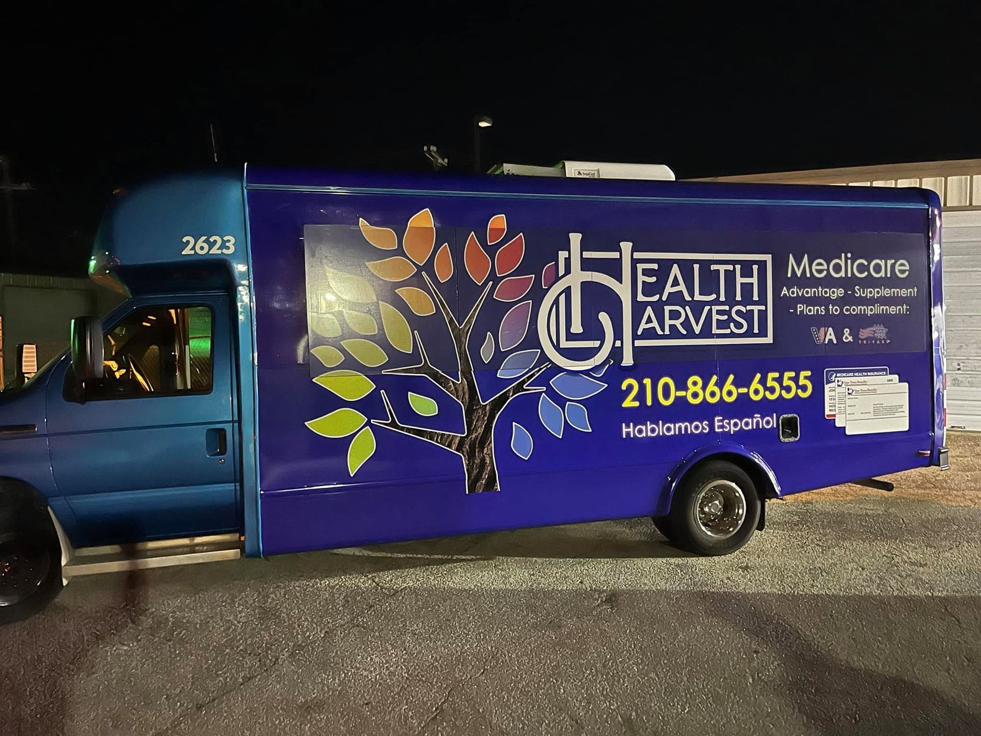 Blue medical transport van with Health Airways and Medicare Advantage advertising on the side.