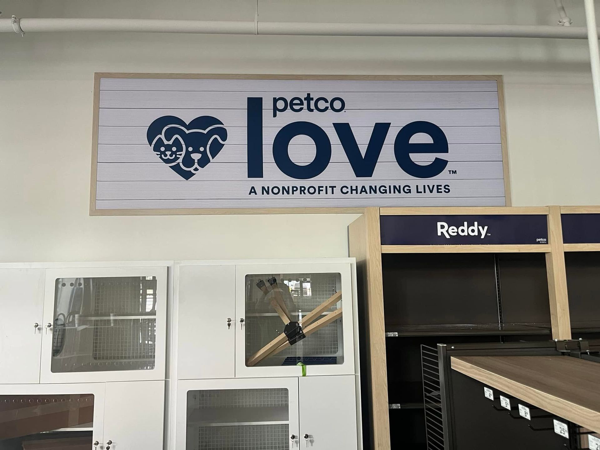 Petco Love nonprofit sign above animal shelter doors, with cat and dog logo