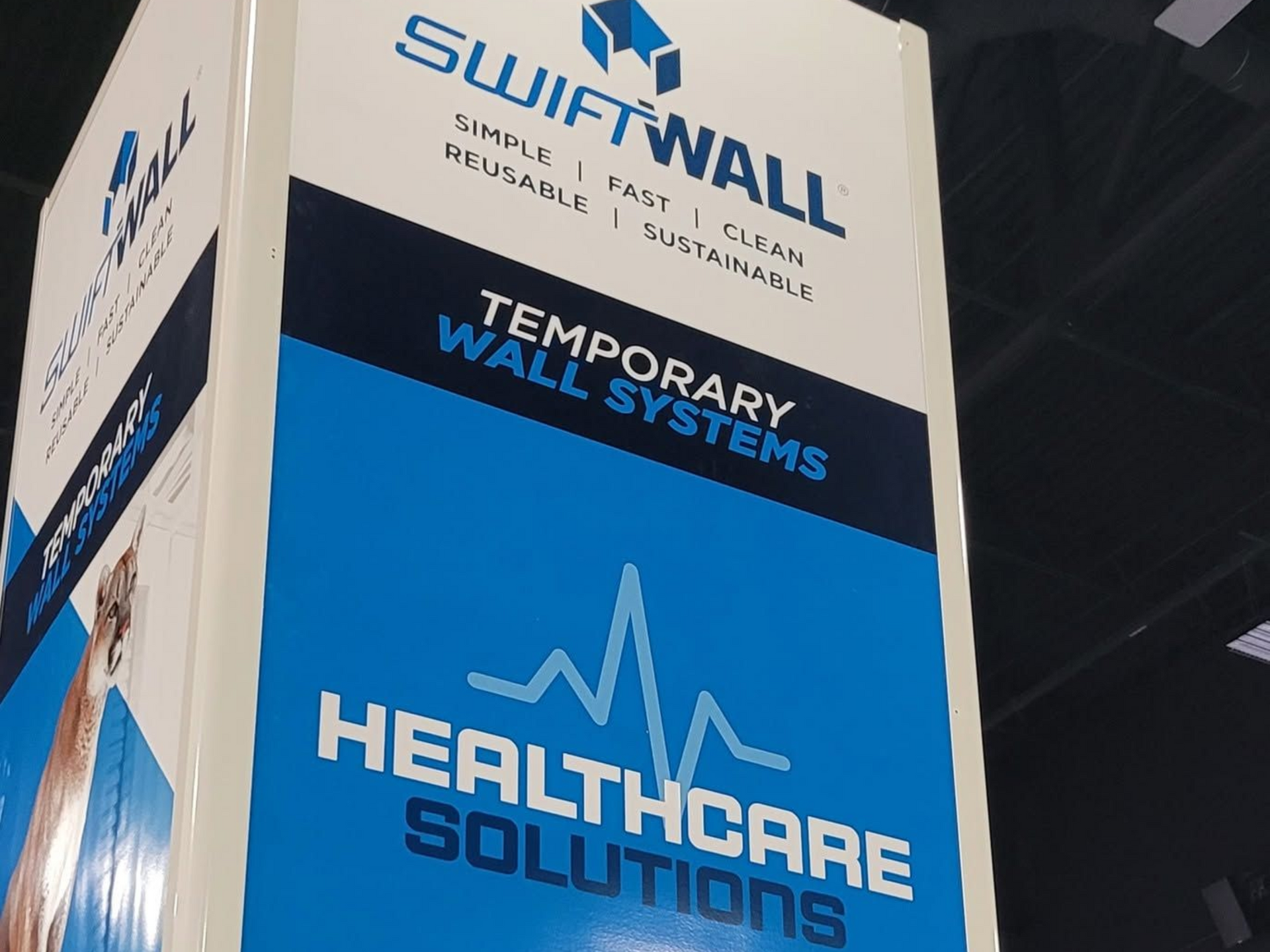 SwiftWall trade show display for temporary wall systems, blue and white healthcare solutions branding
