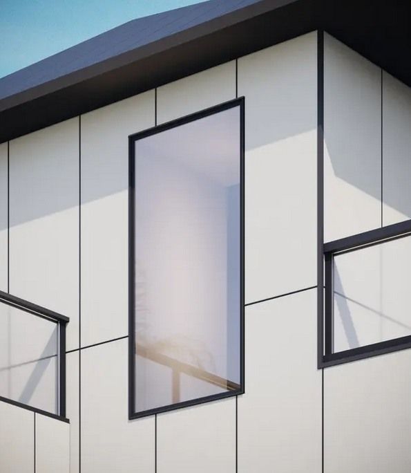 Modern building facade with tall narrow windows against a clear sky