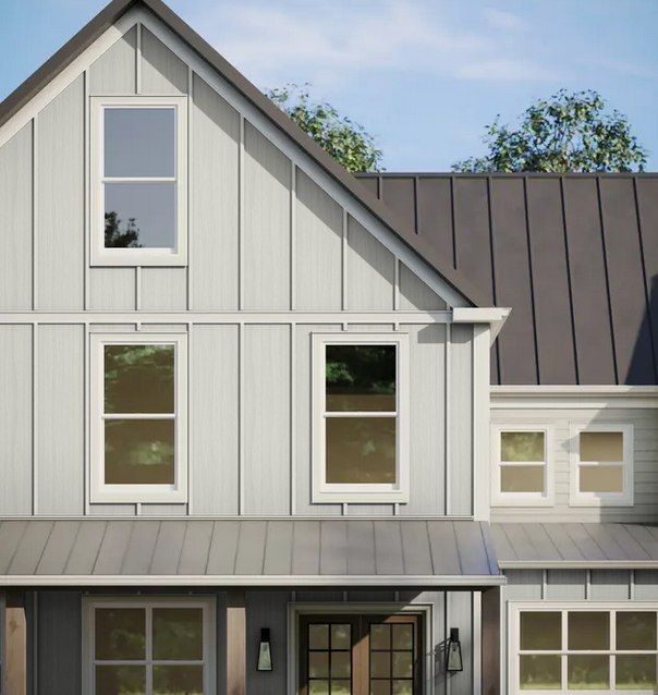 Modern gray-and-white house exterior with gabled roof and large windows