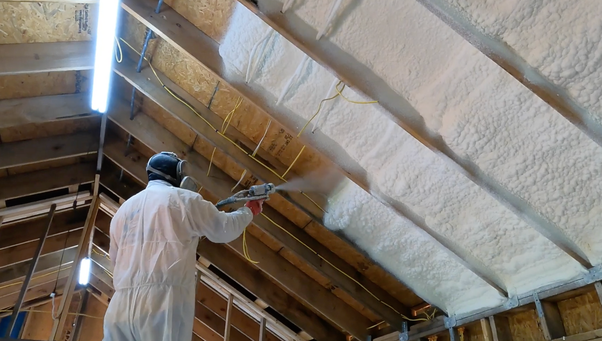 Technician spraying new insulation foam.