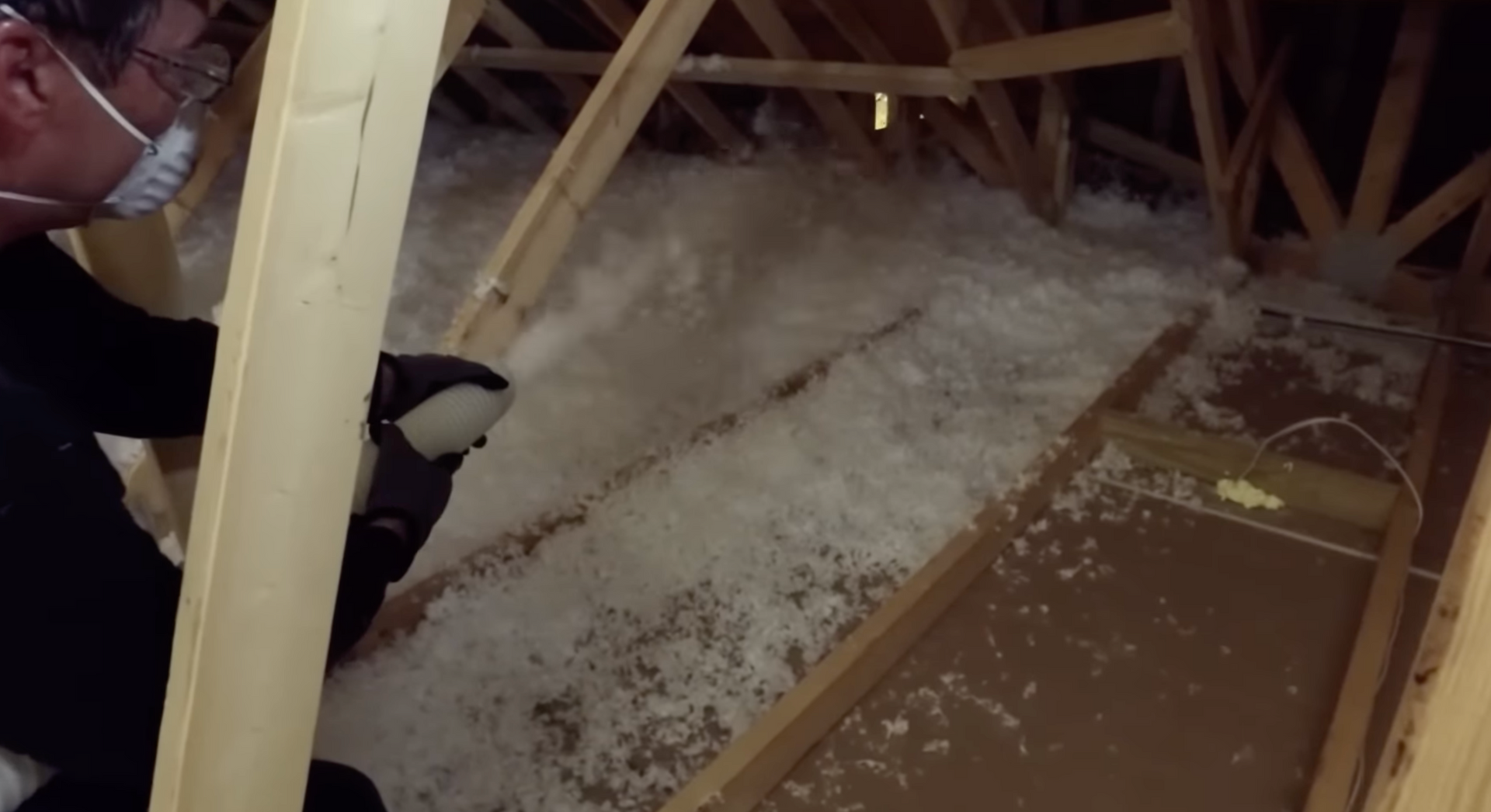 Technician applying blown-in insulation