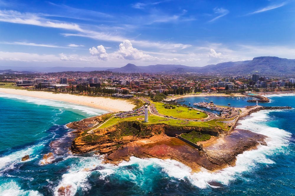 Stunning View Of The Best Beaches In Sydney, With Golden Sands, Crystal Clear Waters, And Vibrant Beach Umbrellas — Sydney Underfloor Heating in Woonona, NSW