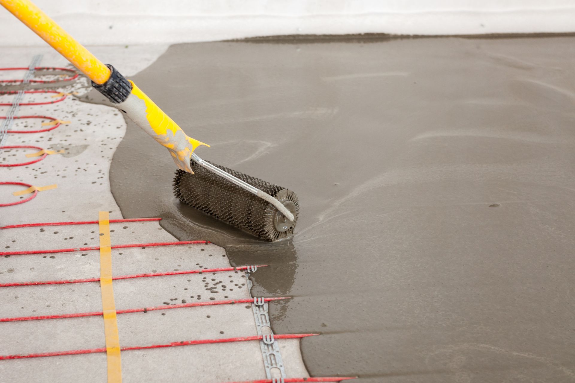 Man Working Underfloor Heating Installation — Sydney Underfloor Heating in Woonona, NSW