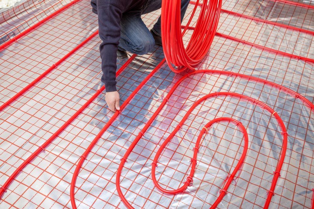 Pipefitter Installing System Of Heating — Sydney Underfloor Heating in Sydney, NSW
