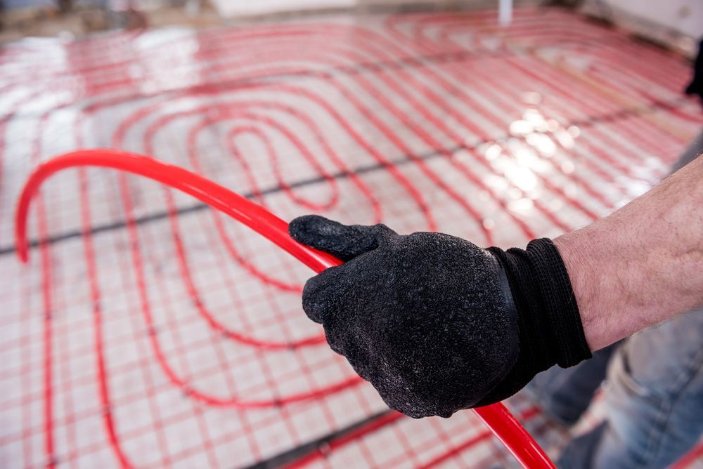 Pipefitter Install System Of Underfloor Heating System At Home — Sydney Underfloor Heating in Wollongong, NSW