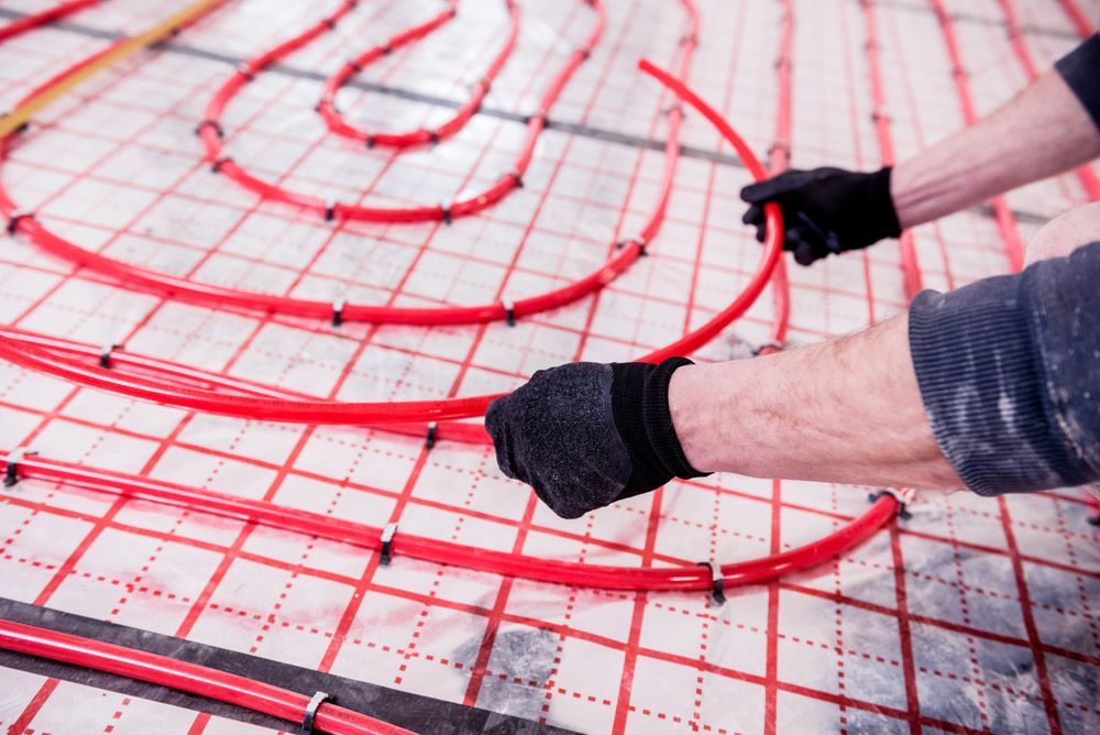 Pipefitter Install System Of Underfloor Heating System At Home — Sydney Underfloor Heating in Woonona, NSW