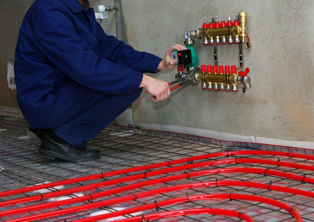Plumber Installing Plastic Pipes for Underfloor Heating — Sydney Underfloor Heating in Woonona, NSW