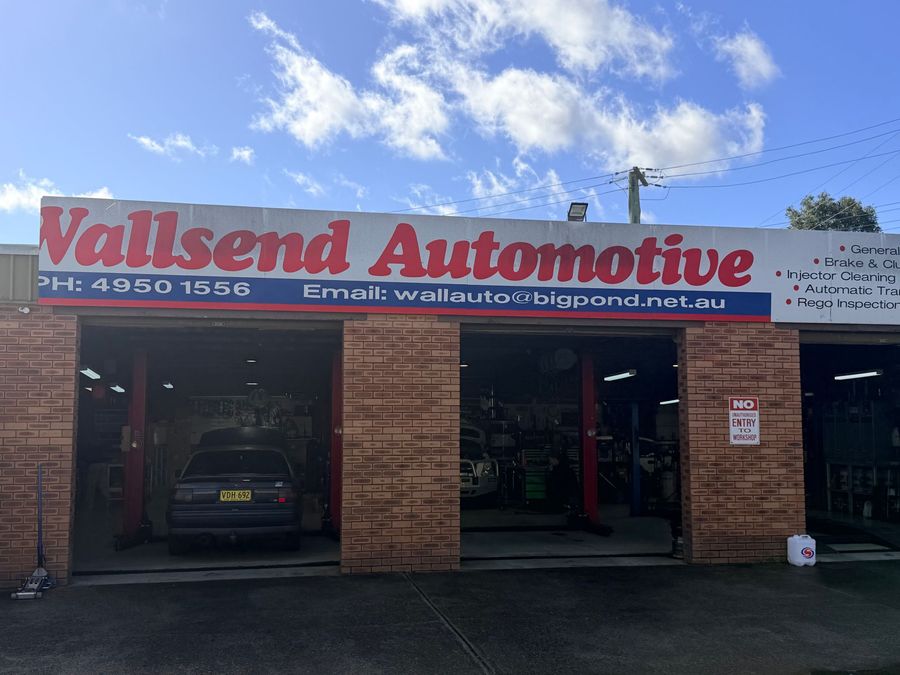 Wallsend Automotive storefront with open garage bays and a parked car inside