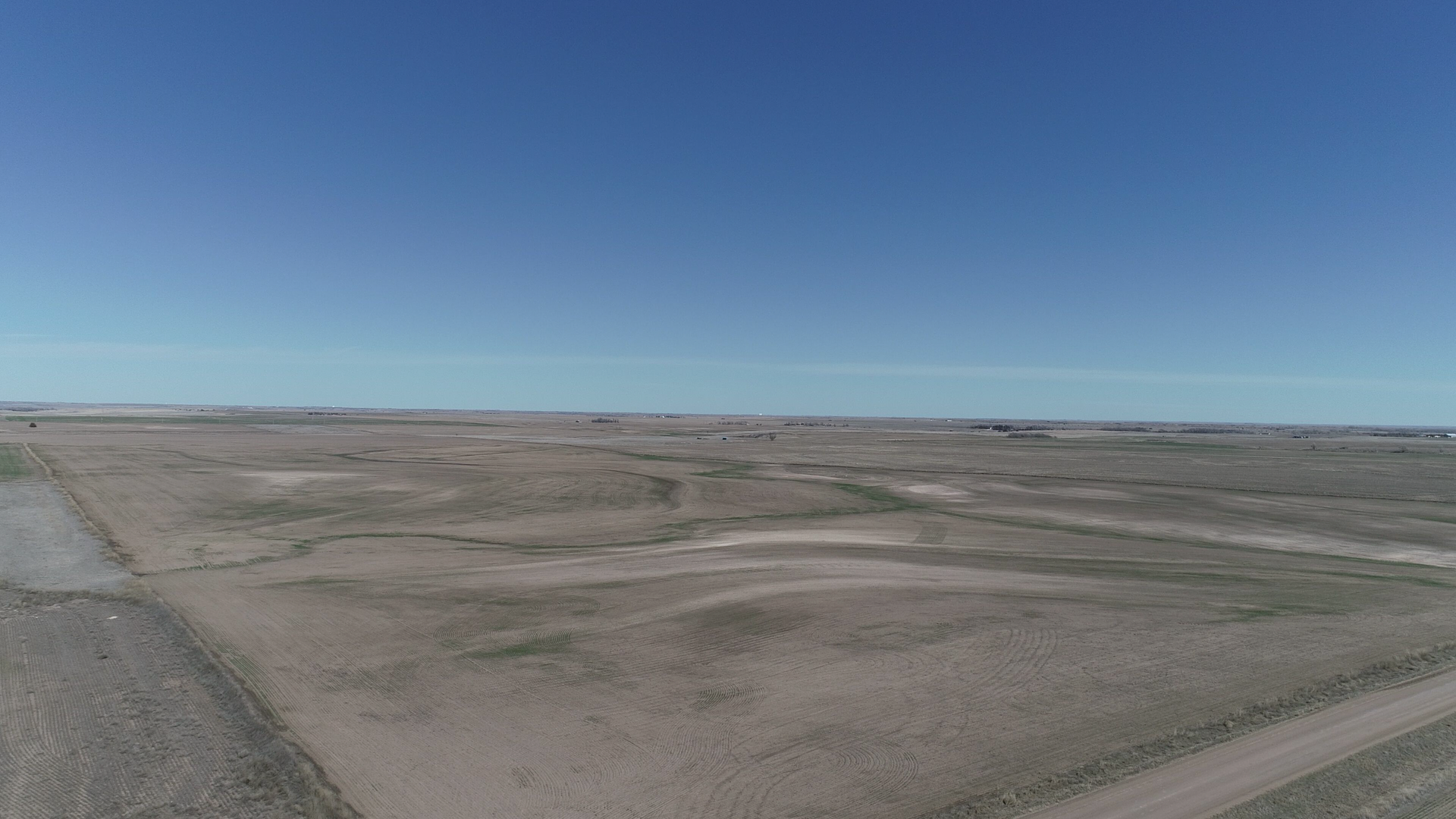 An aerial view of a dirt road in the middle of a desert.