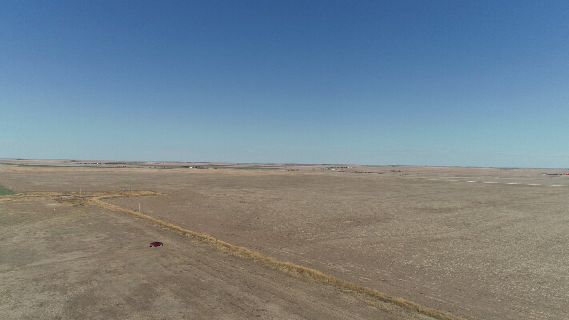 An aerial view of a desert landscape with a blue sky in the background.