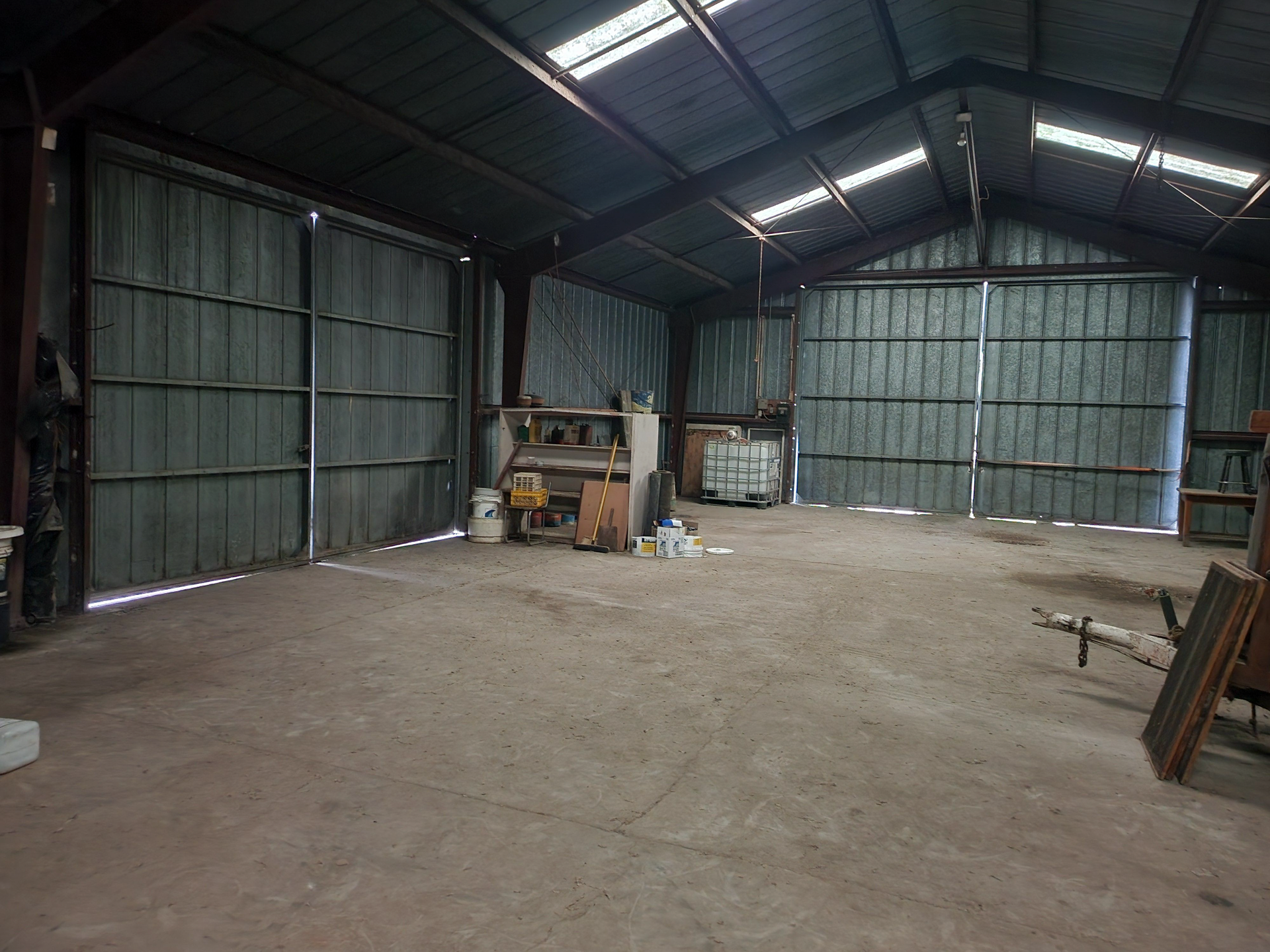 A large empty warehouse with a sliding door