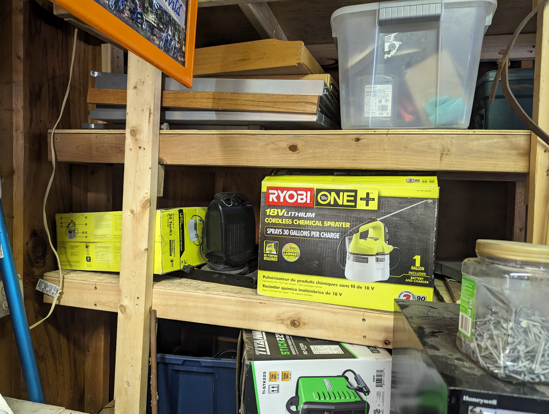 A ryobi vacuum cleaner is sitting on a wooden shelf