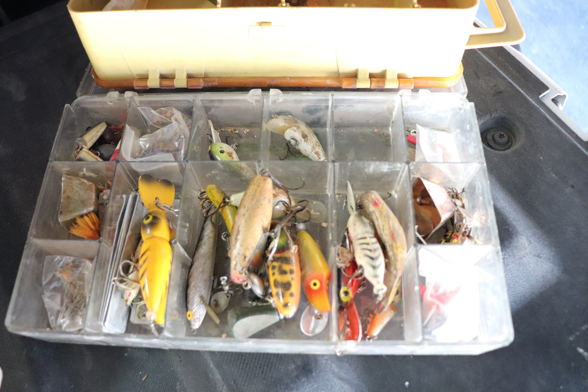 A fishing tackle box filled with lots of fishing lures