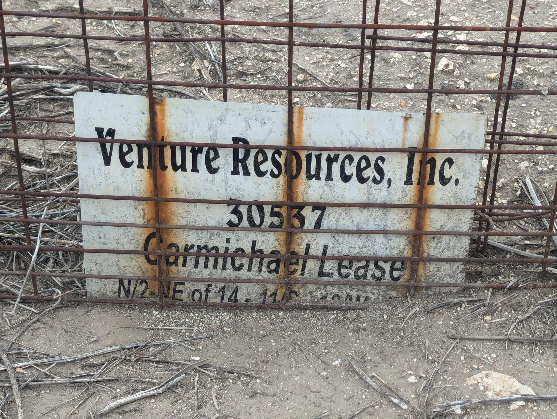 A rusty sign that says venture resources inc. on it