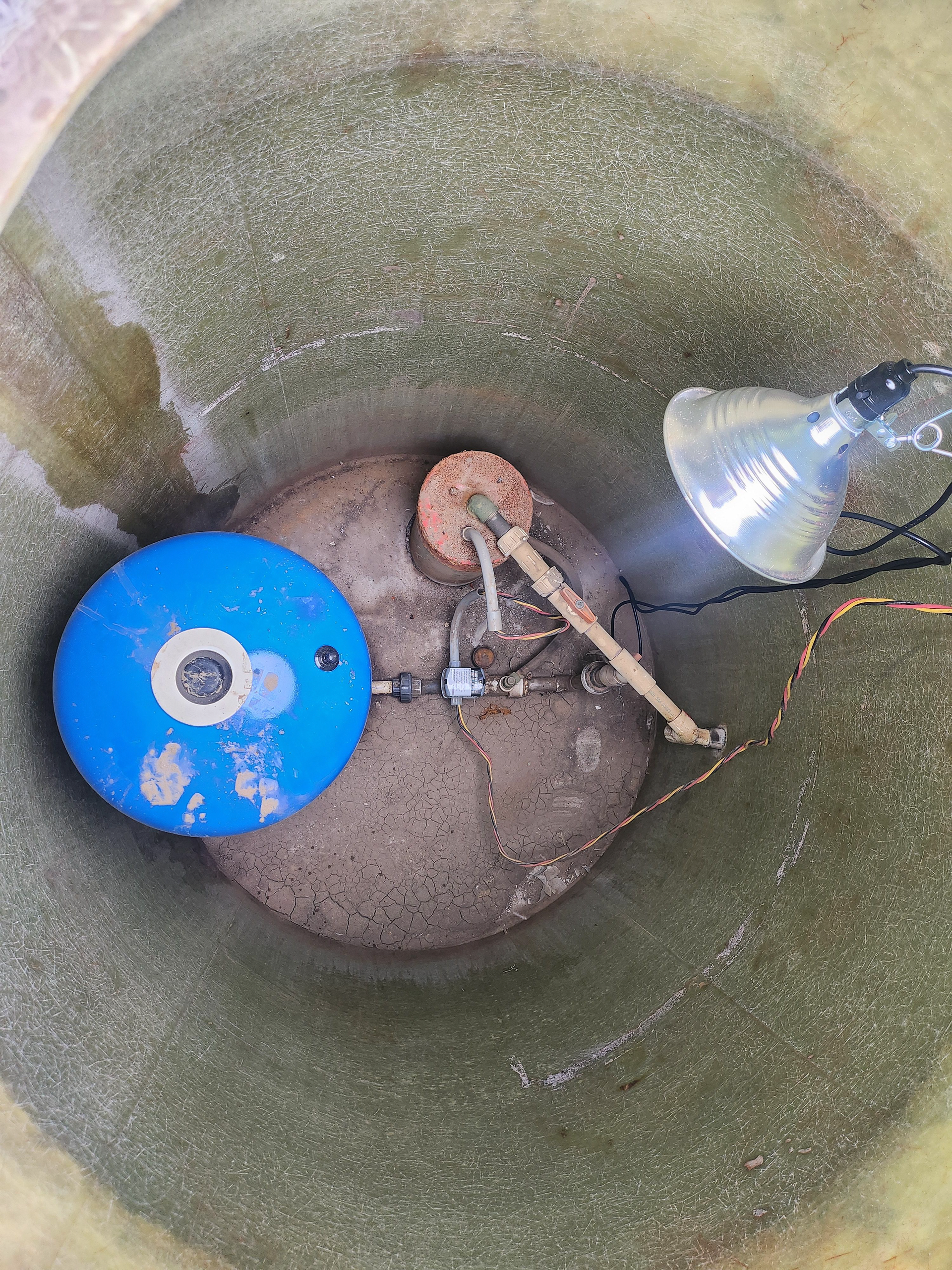 There is a blue object in the middle of a hole.