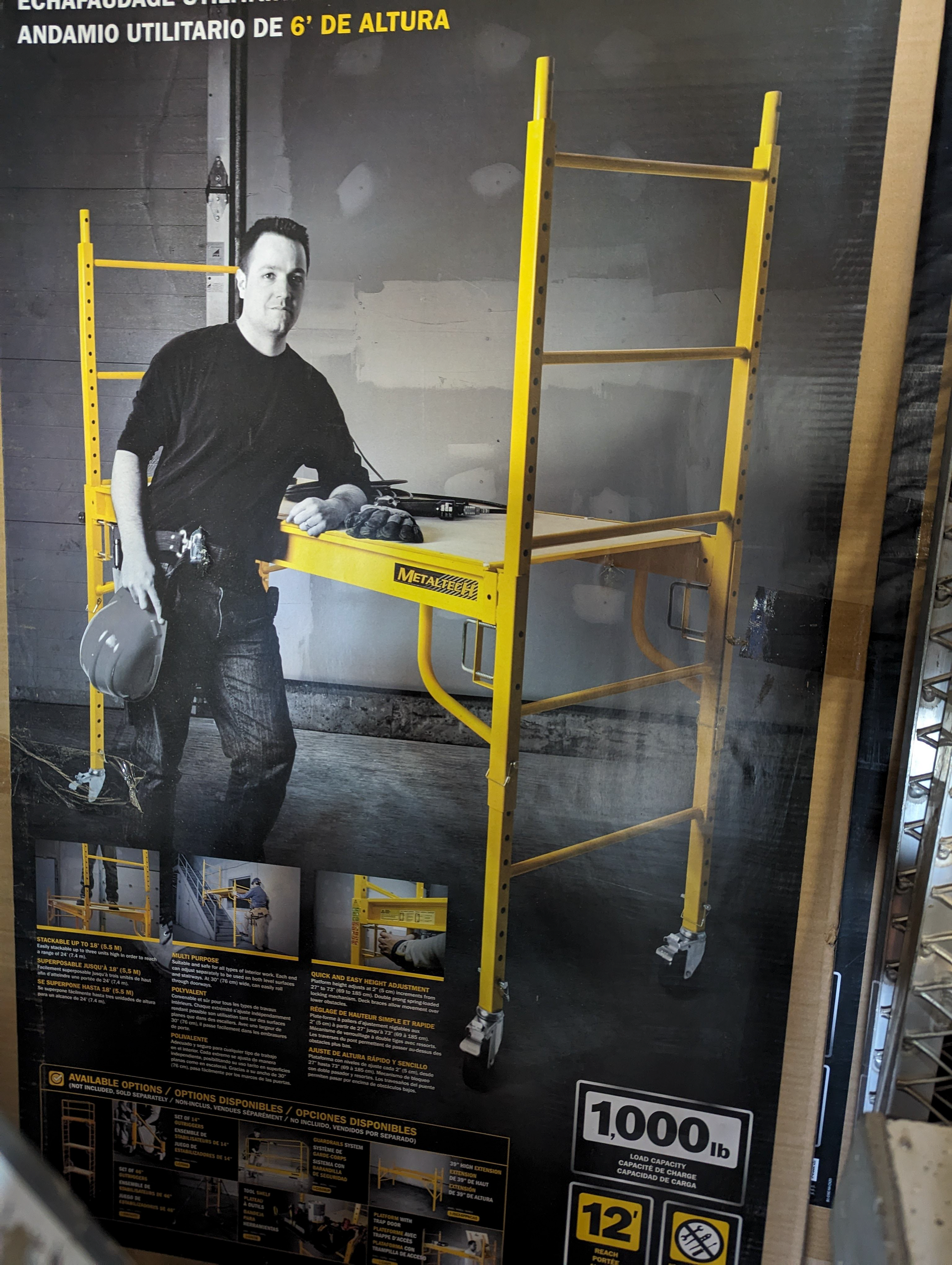 A picture of a man standing next to a scaffolding with the number 1000 on it