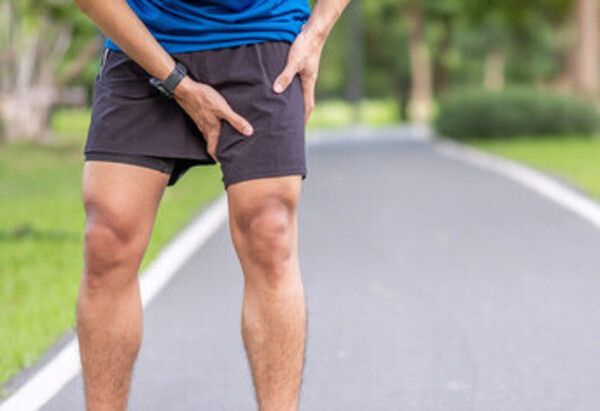 man with hip tendonitis pain after running