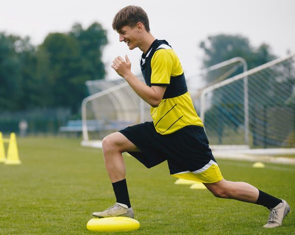 boy doing stretching exercises as part of adolescent physiotherapy in cheltenham