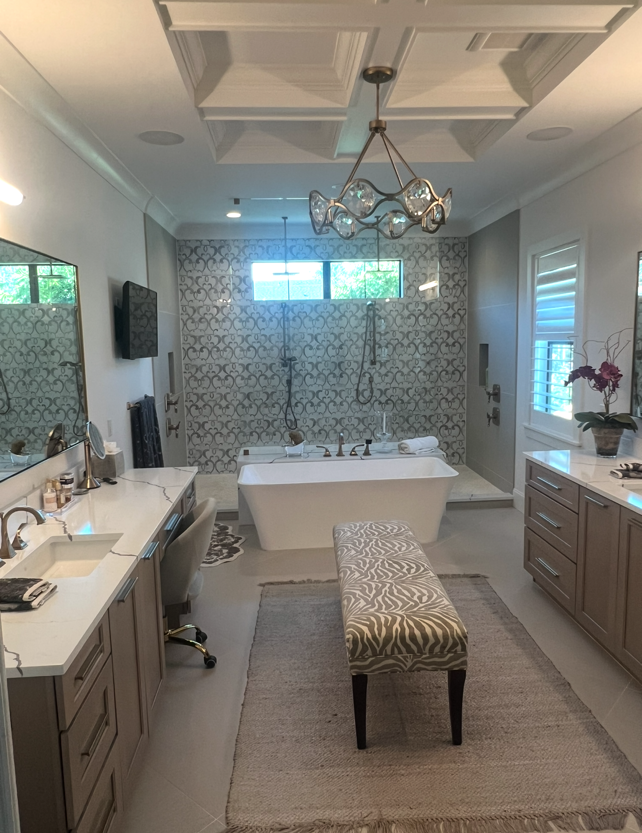 Luxurious bathroom with soaking tub, glass shower, and double vanity. Neutral colors and elegant fixtures.