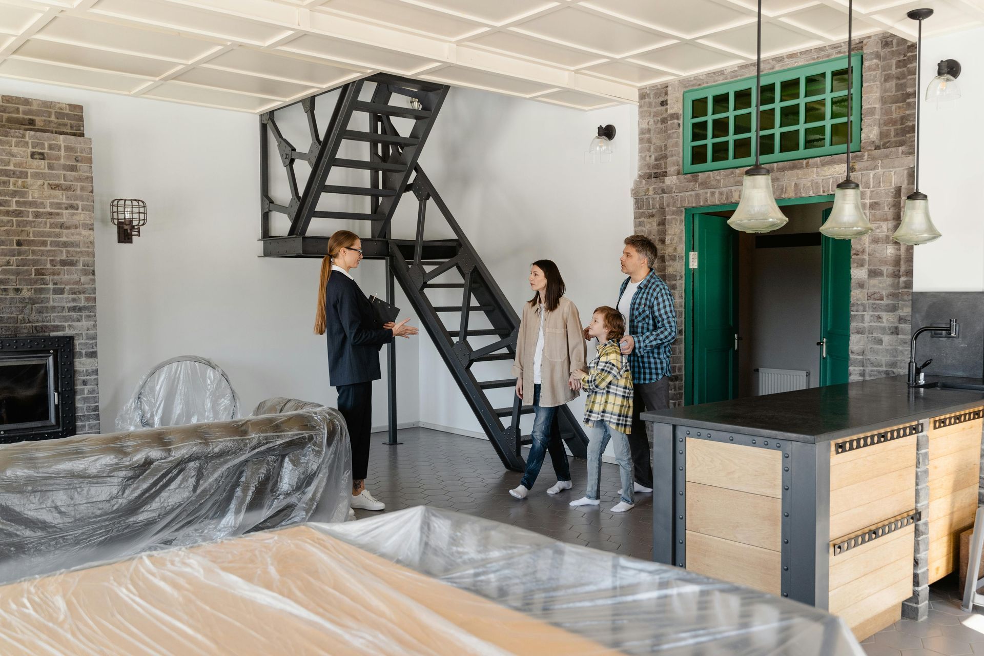 A family is looking at a house that is being remodeled.