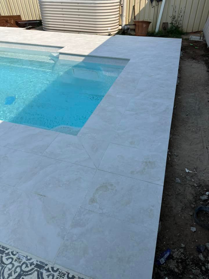 Pool With Light Gray Stone Coping and a Small Built-in Step Area — East Coast Paving in Medowie, NSW