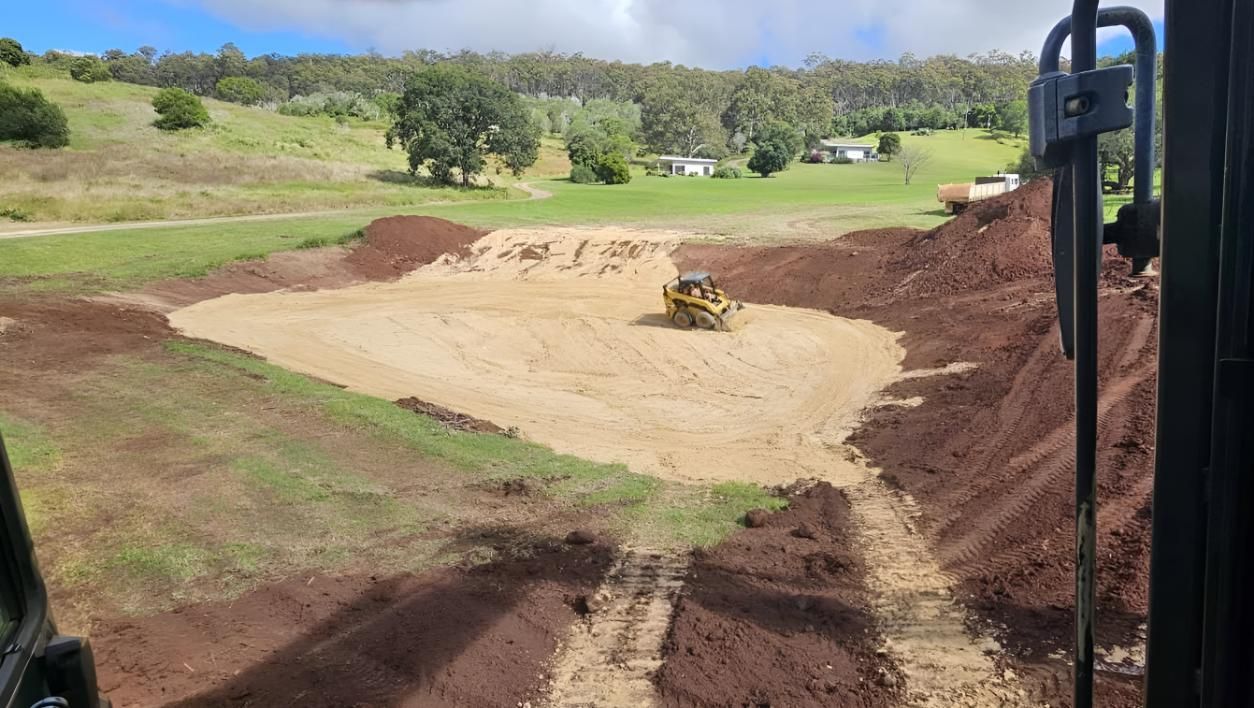 A Bulldozer Is Moving Dirt In A Field — Greenslade's Dozer & Excavator Hire Pty Ltd In Taabinga, QLD