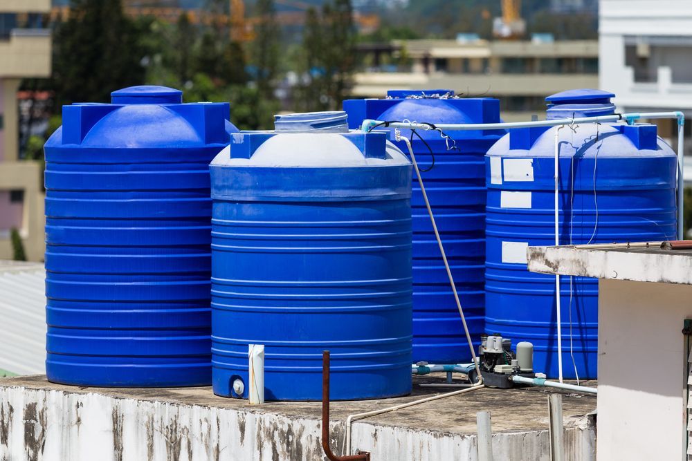 Blue Water Storage Tanks on a Rooftop — Raptor Waste Management In Currumbin Valley, QLD
