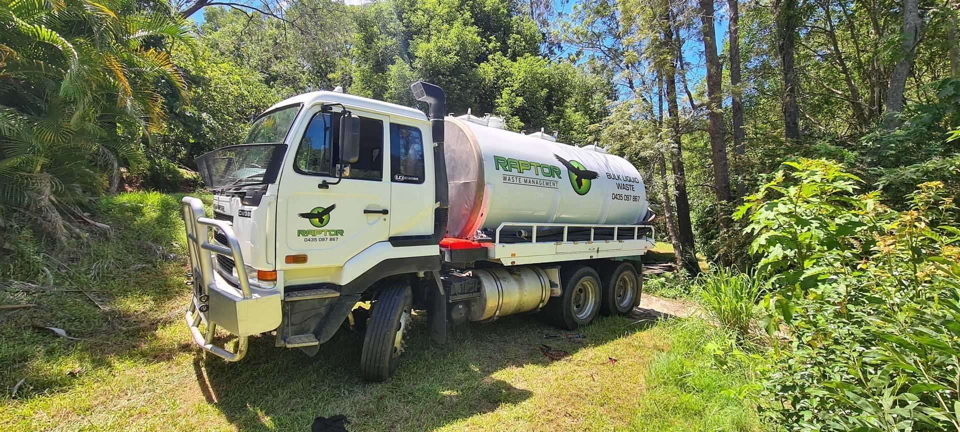 White Tanker Truck With Logo on Side Parked on Grassy Edge of Woods  — Raptor Waste Management in Coolangatta, QLD
