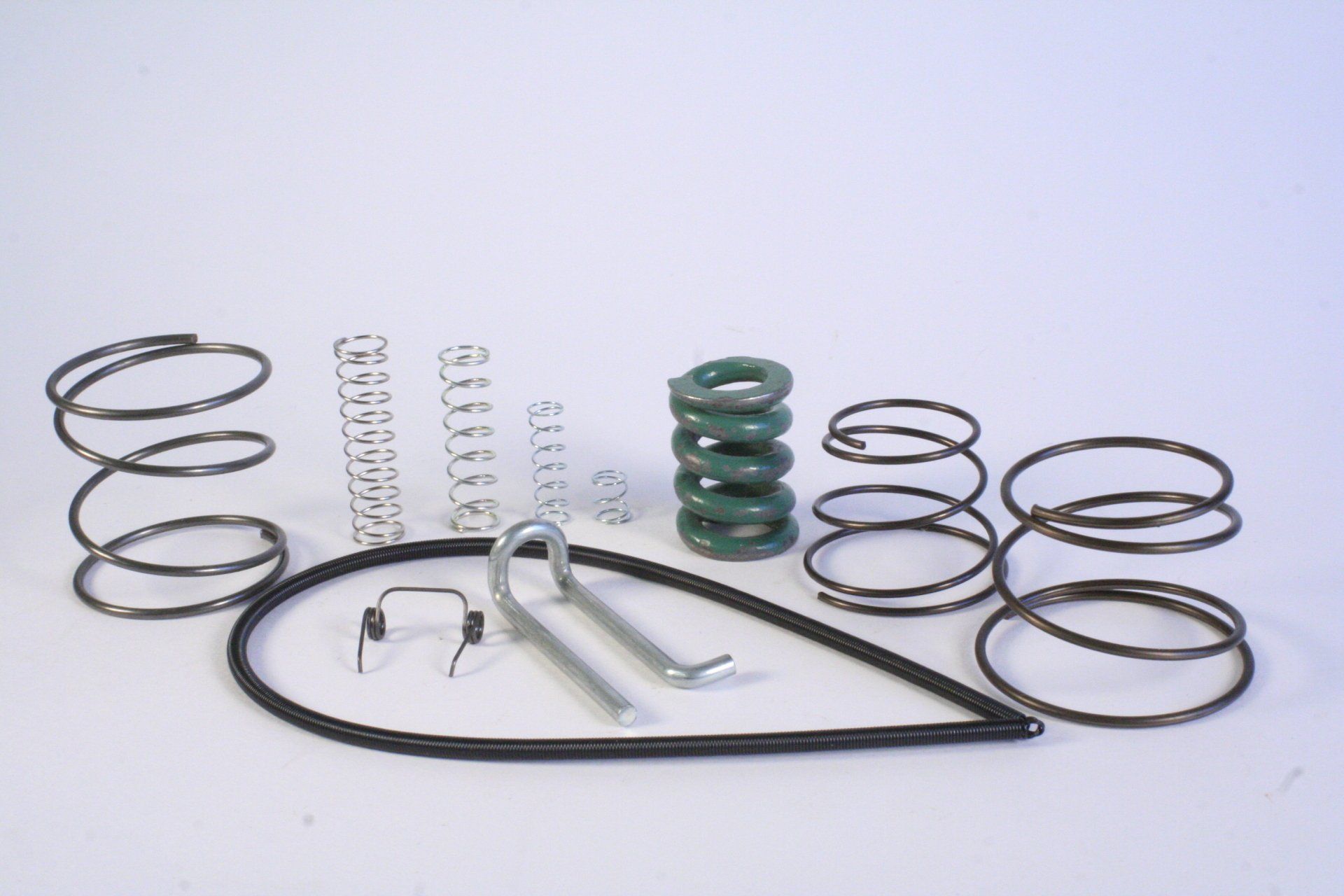 A bunch of different types of springs on a white surface