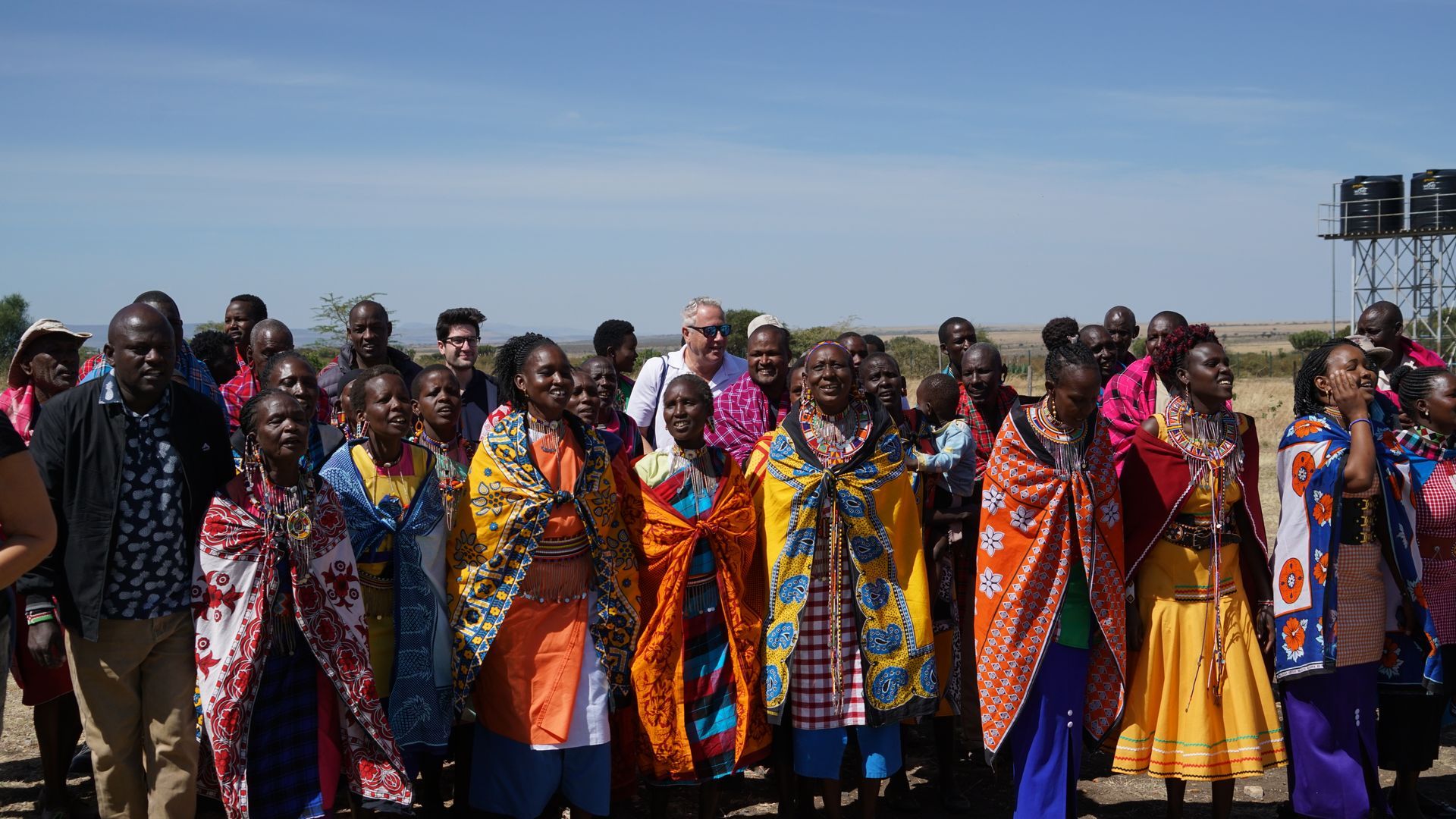A group of people standing next to each other in a field.
