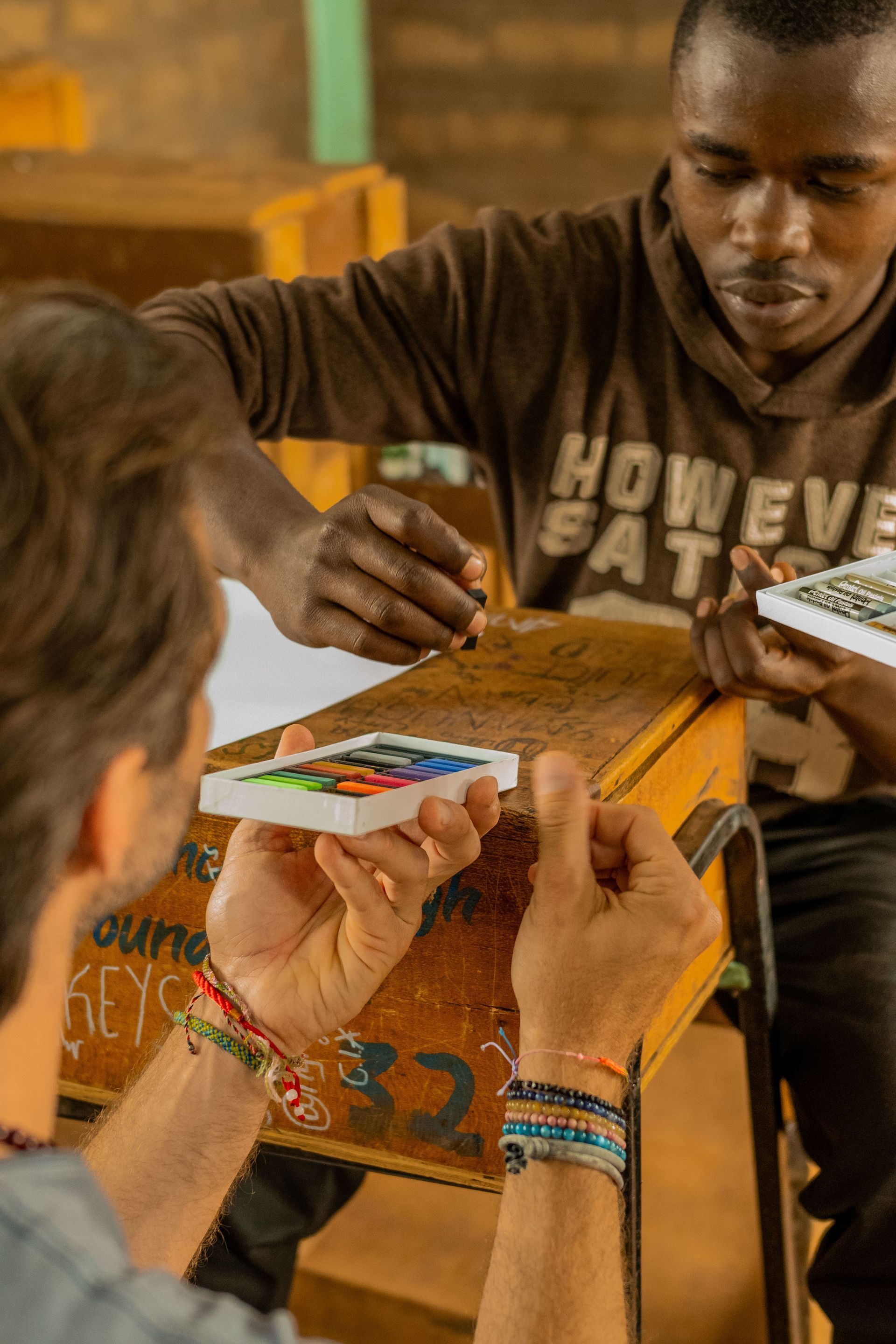 Two men are sitting at a table playing a game of cards.
