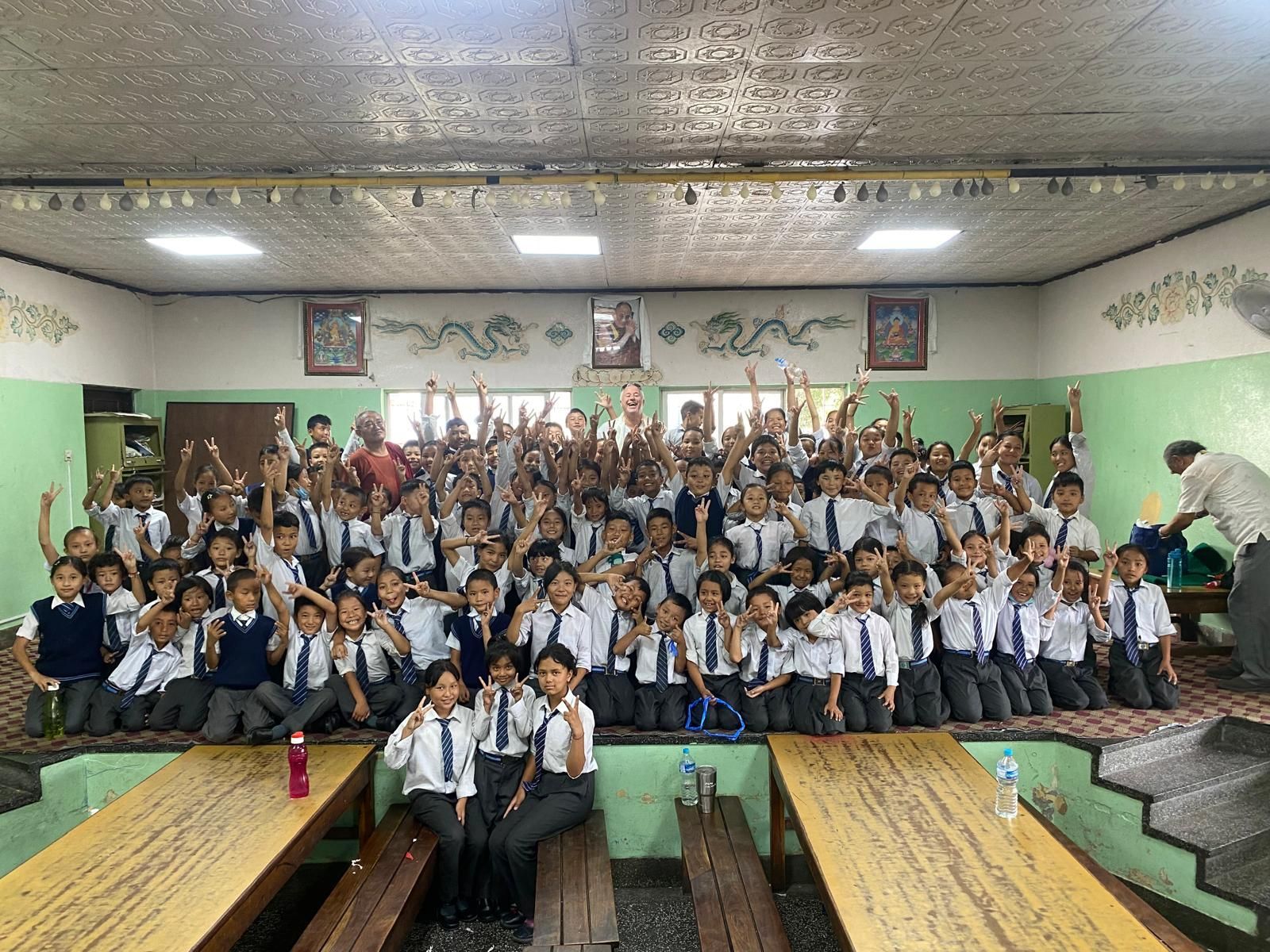 A large group of Nepalese children are posing for a picture in a classroom Andy Stein of orphaned starfish foundation