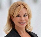 A woman with blonde hair and a black jacket is smiling for the camera. JEANETTE PRENGER