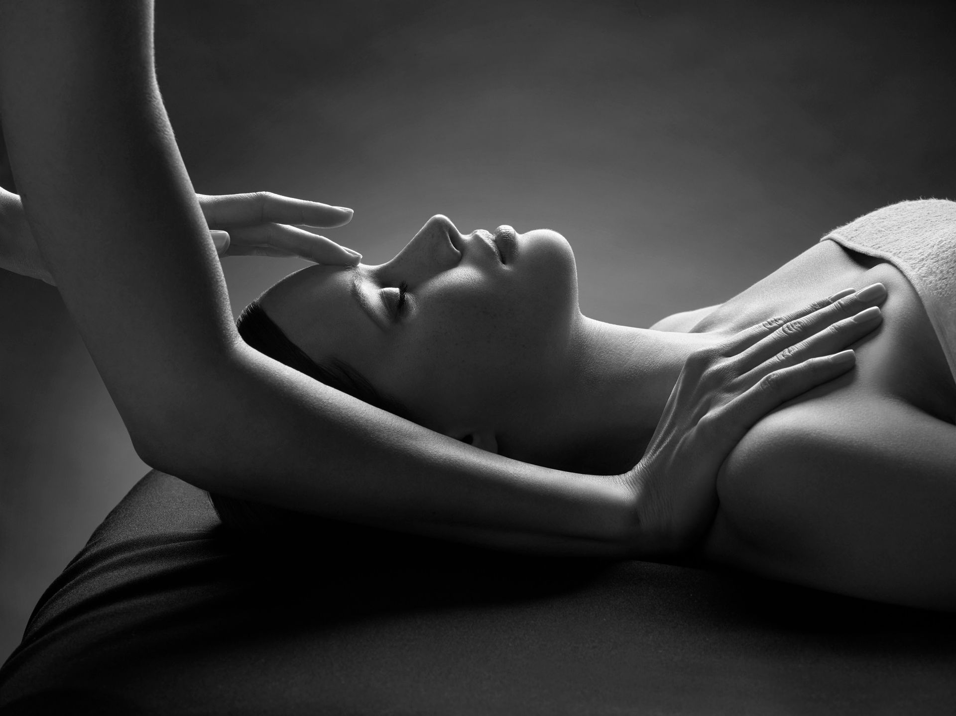 A black and white photo of a woman getting a massage