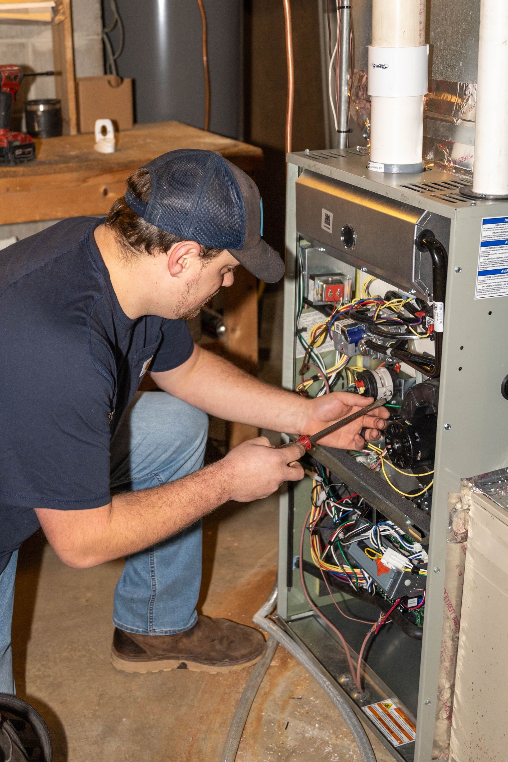 Blue Yeti technician working at a furnace