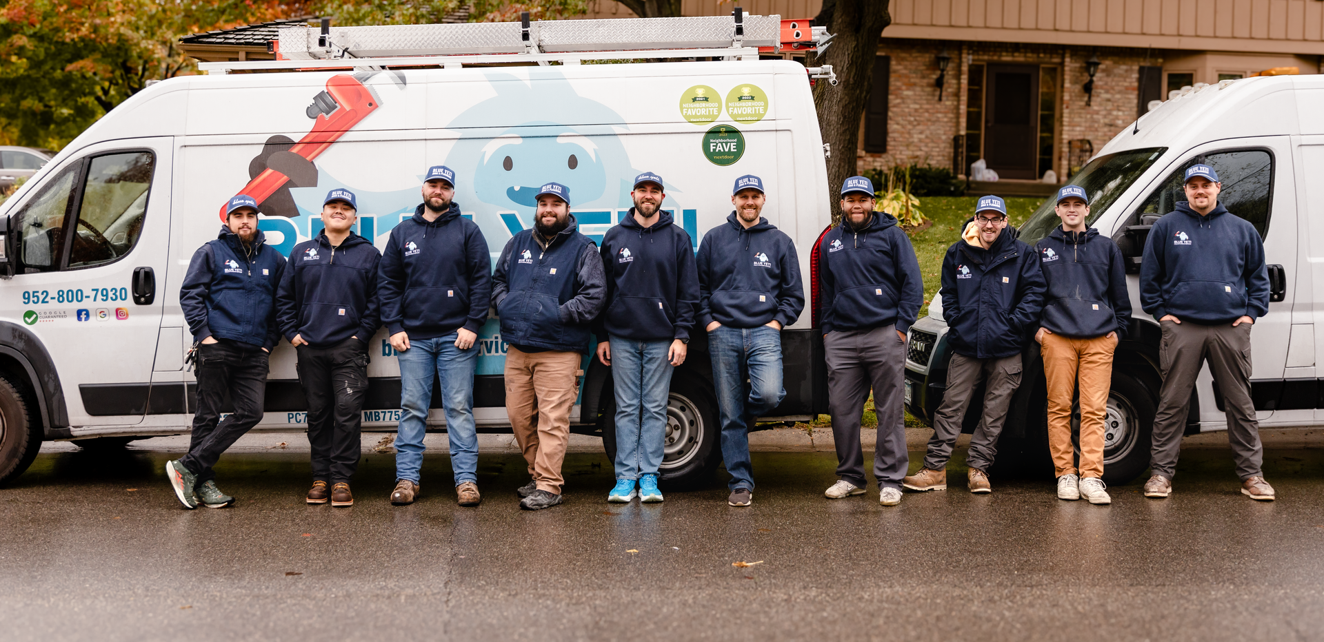 Blue Yeti technicians standing with branded service vans