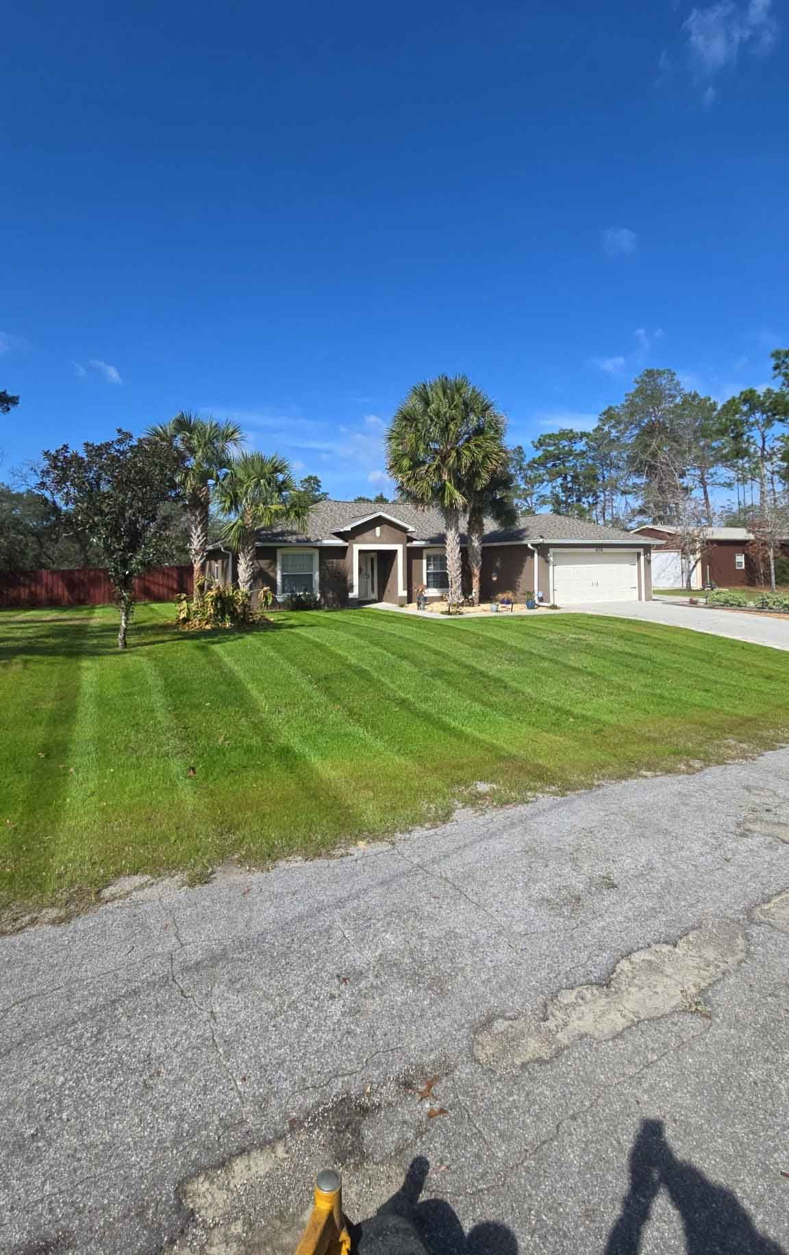 A large house with a lush green lawn in front of it.