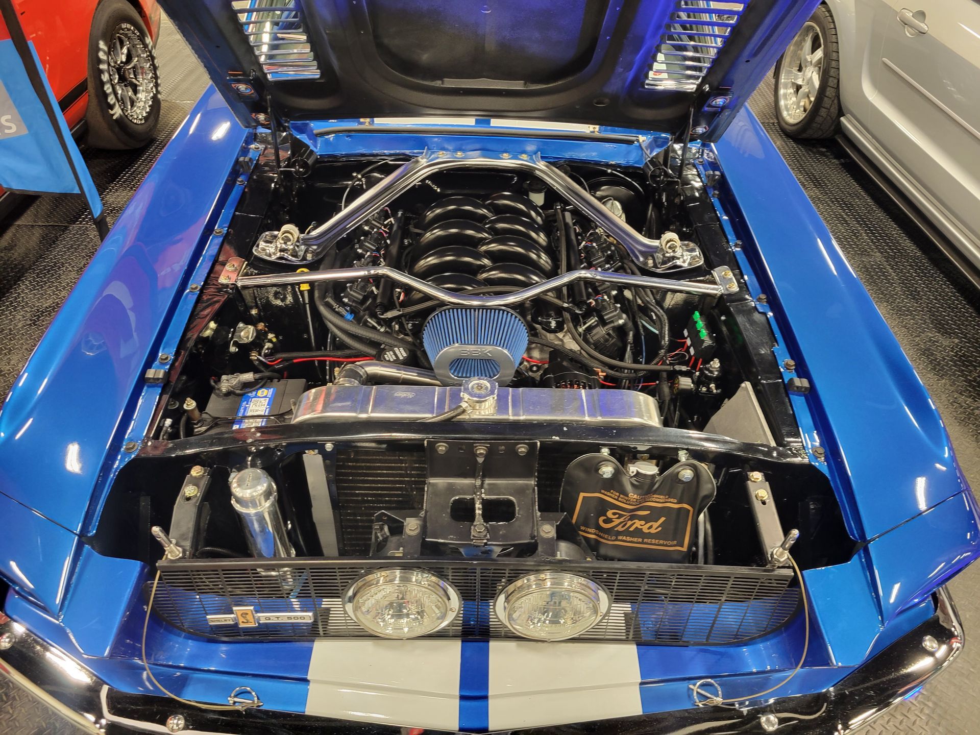 Two 7.3L swapped Mustangs at world of wheels in calgary in the Lakeview Automotive booth